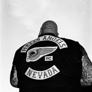 A man in a black jacket with a motorcycle club logo.
